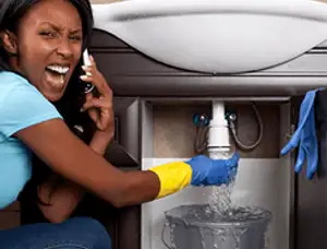 Emergency plumbing repair for a leaking sink drain under a bathroom vanity in Greensboro, NC