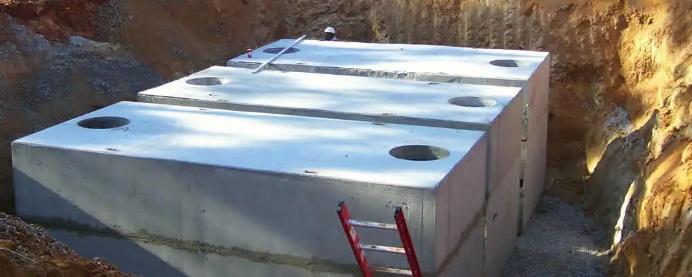 Septic tank installation site with a newly placed concrete tank in Greensboro, NC